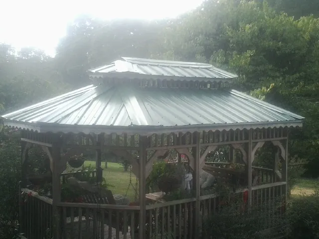 Two tier green metal roof on a garden gazebo in Girard