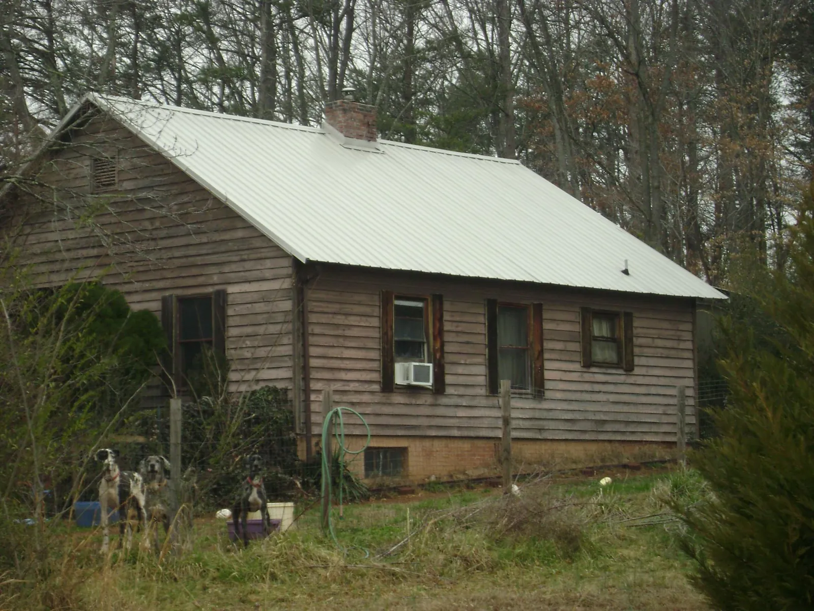 White metal roof on an old wood sided farmhouse, from a Metal Roof Installation job in Girard